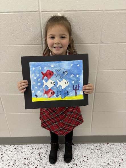 student with their artwork