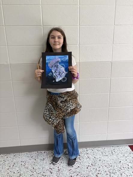 student with their artwork
