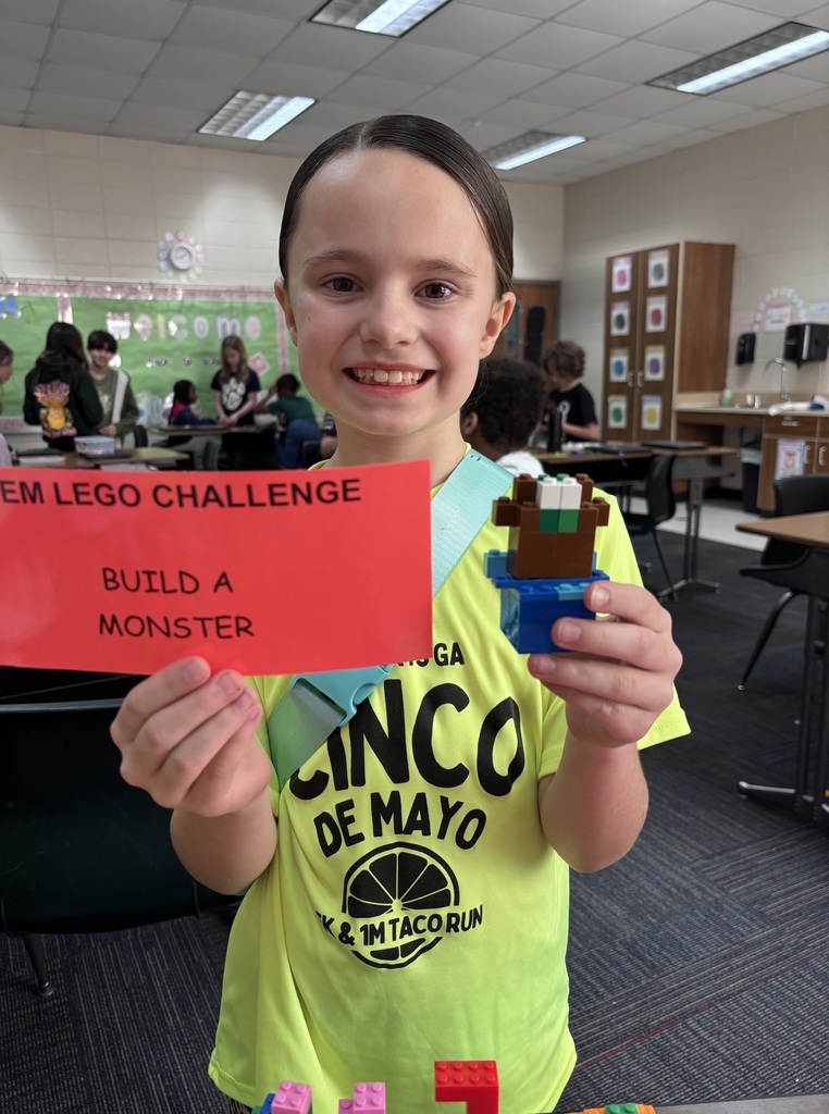 students showing their LEGO prompt and what they created