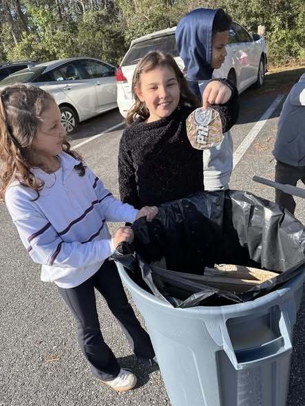 students cleaning up trash around the campus