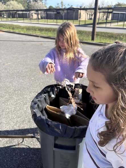 students cleaning up trash around the campus