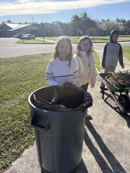 students cleaning up trash around the campus