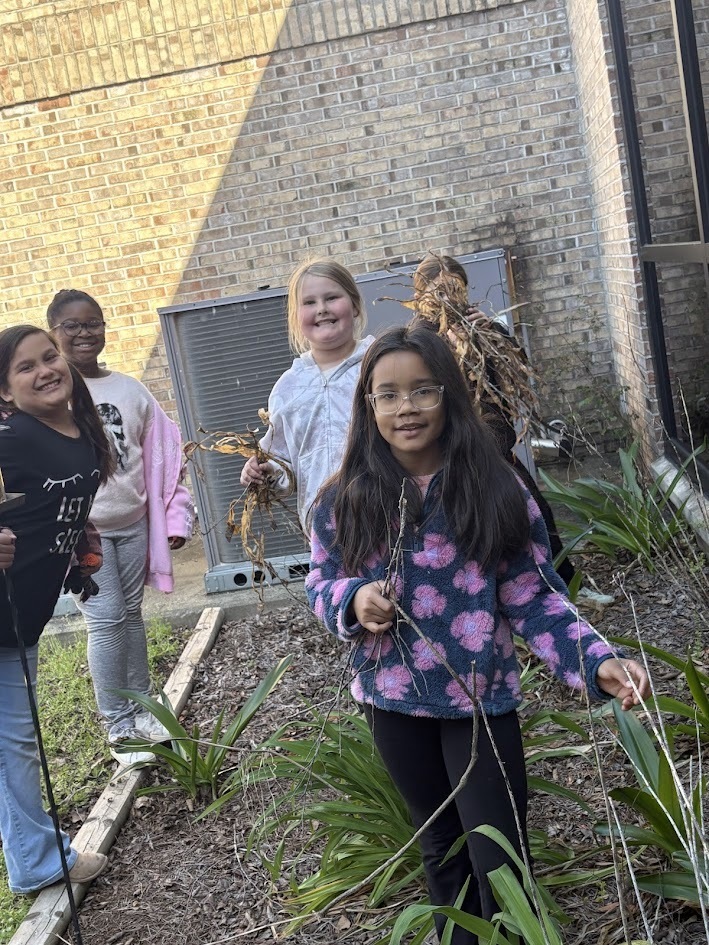 students pulling weeds