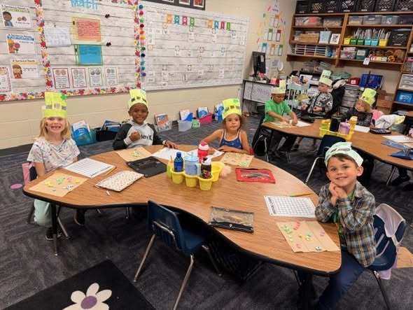 students at their tables doing assignment