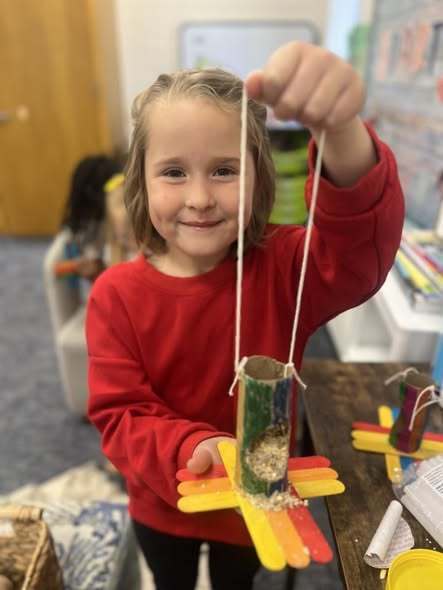 student holding up project