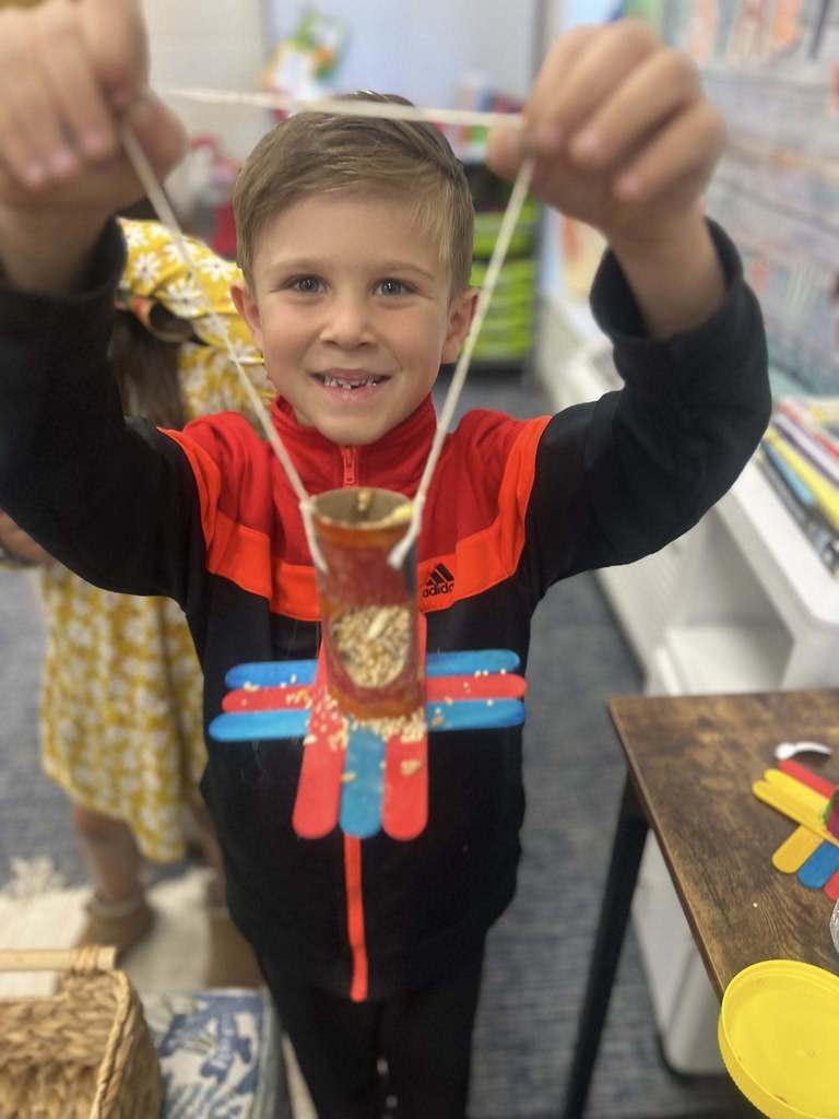 student holding up project