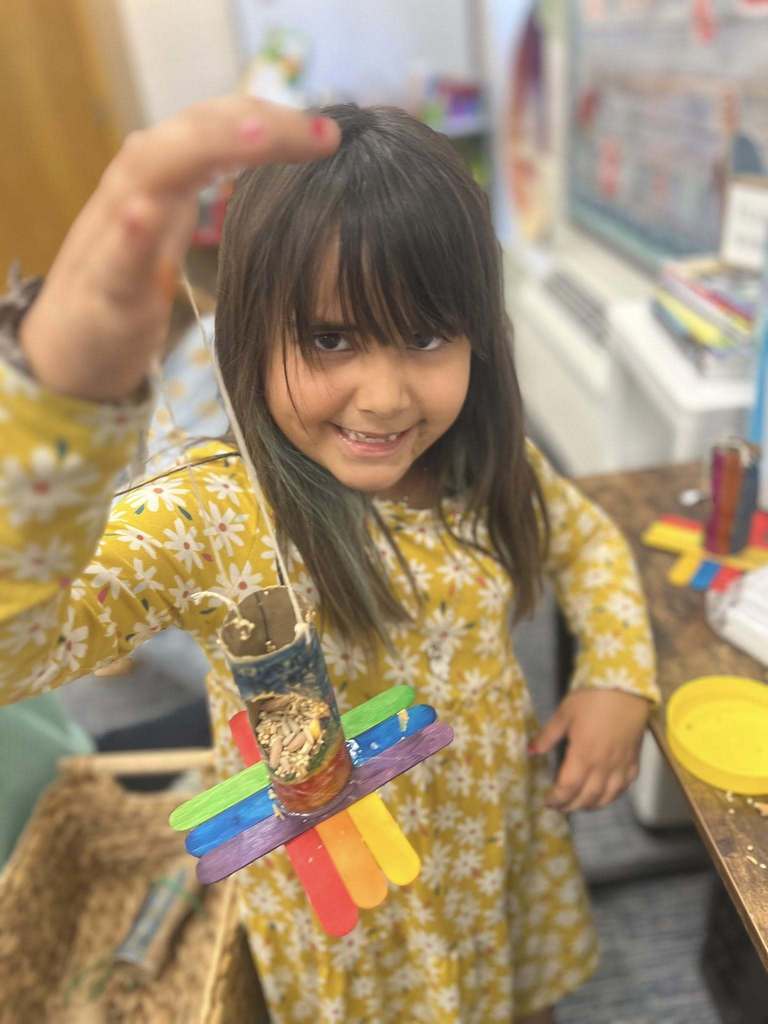 student holding up project