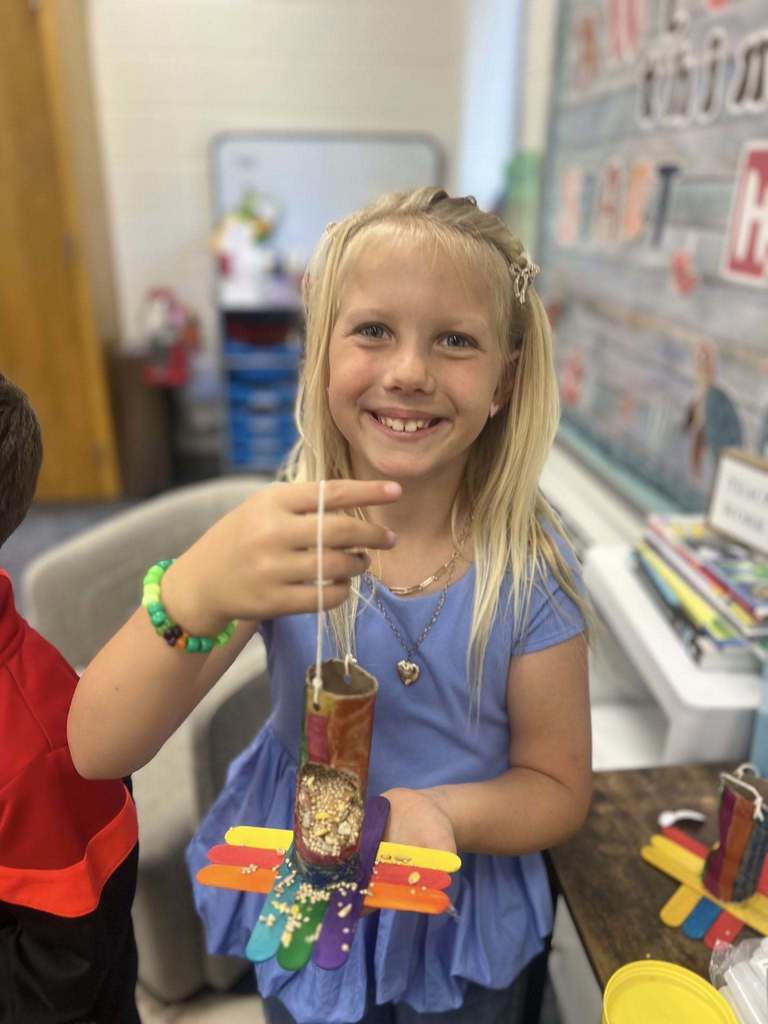 student holding up project