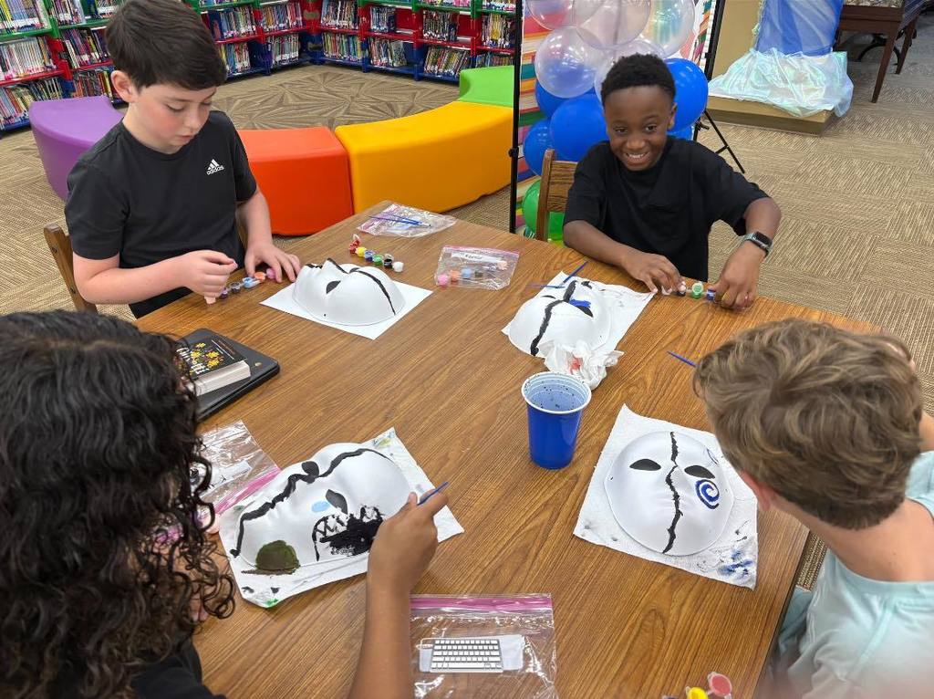students painting masks