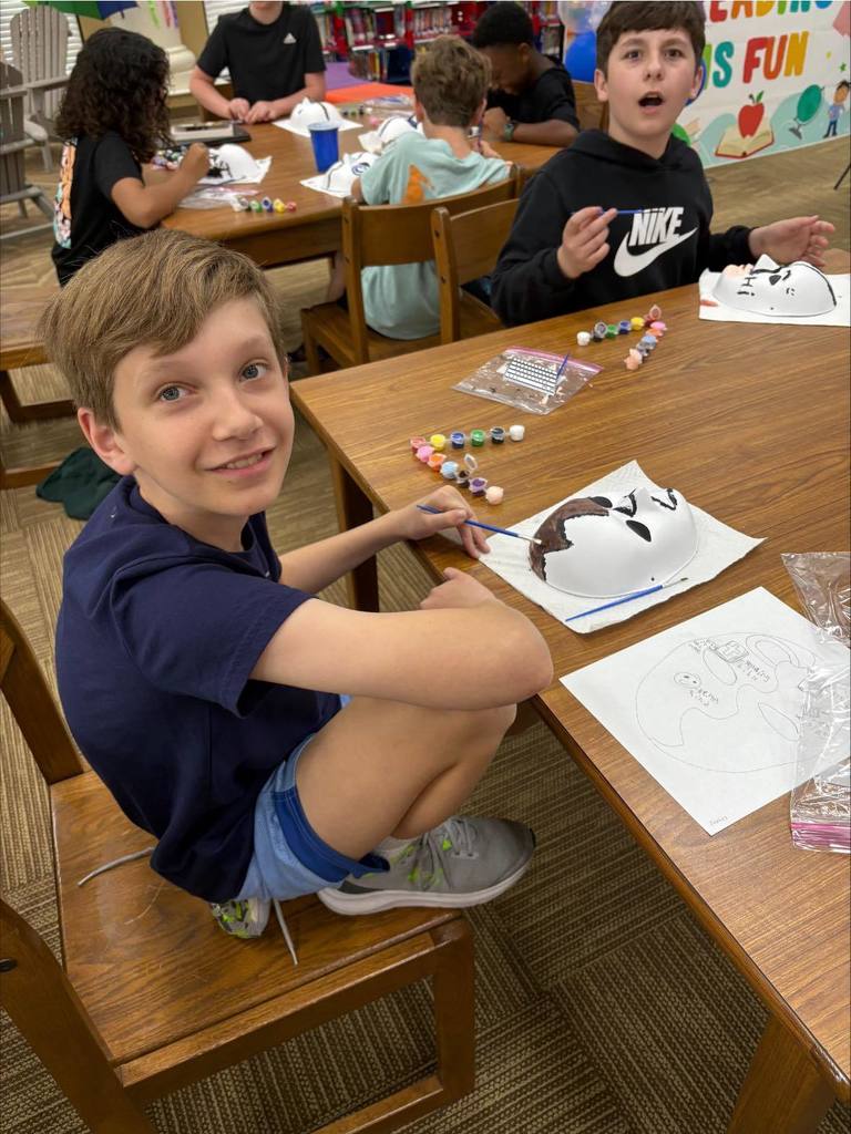 students painting masks