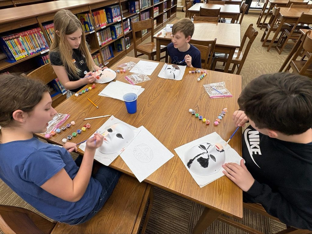 students painting masks