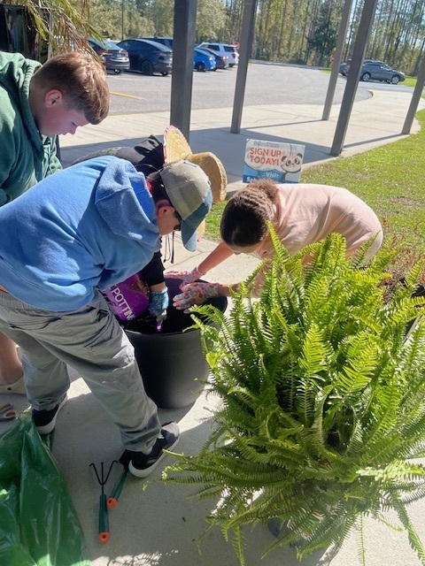 students potting plants