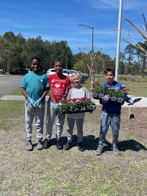 students holding plants