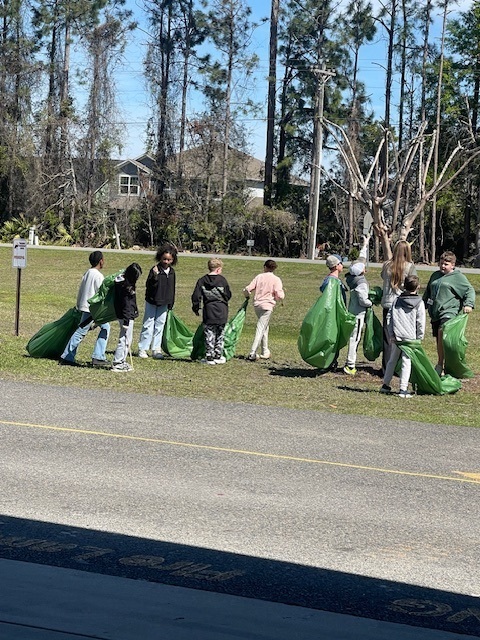 student picking up trash