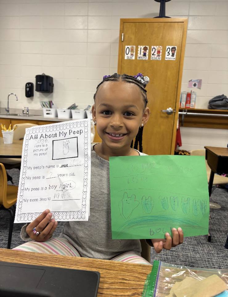 student with her paper about her peep