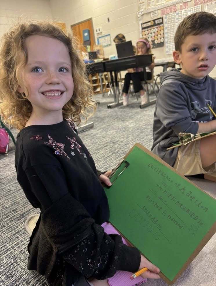 student with peep certificate of adoption paper