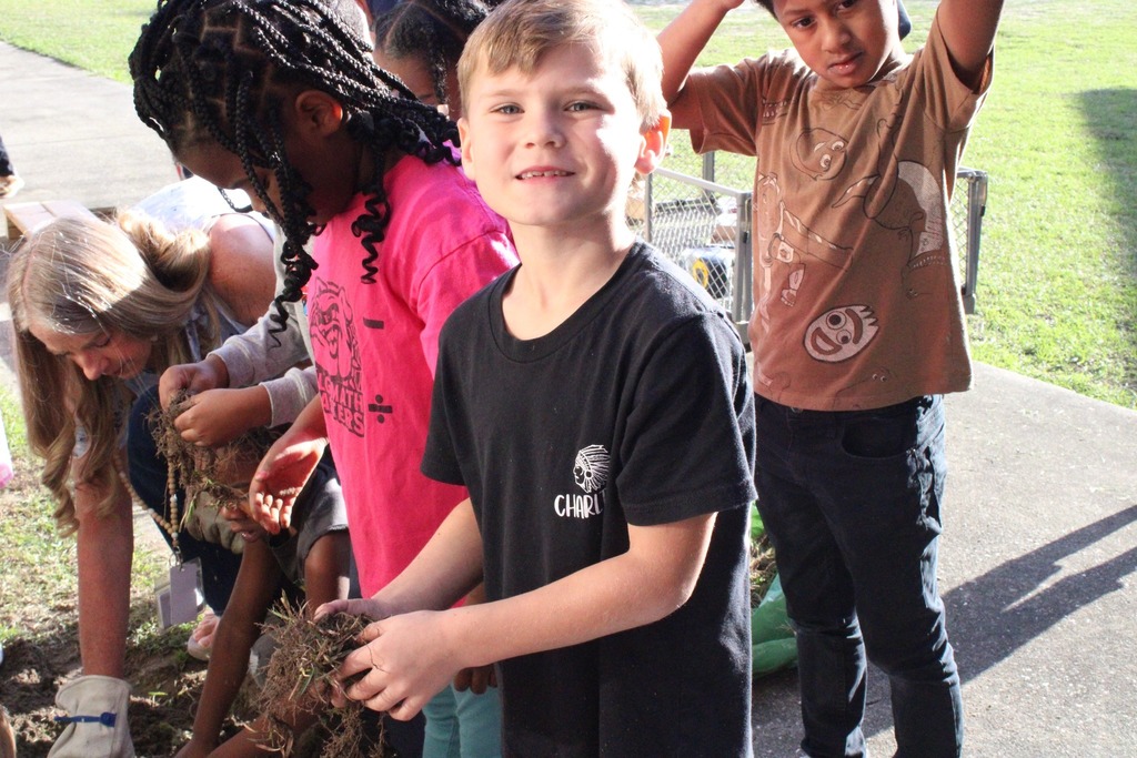 students digging weeds
