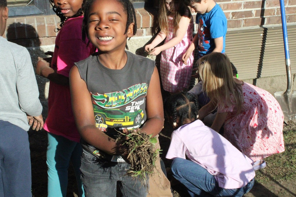 students digging weeds