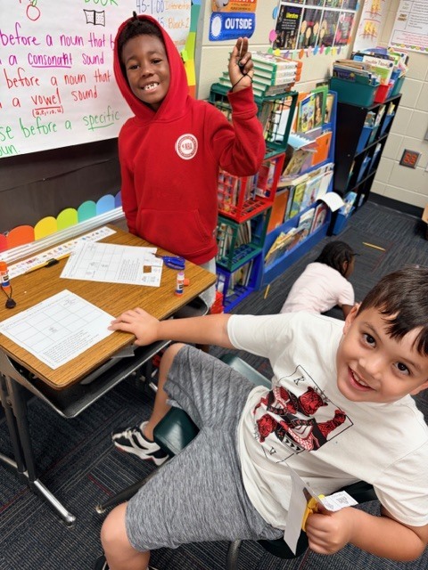 students practice using a compass rose