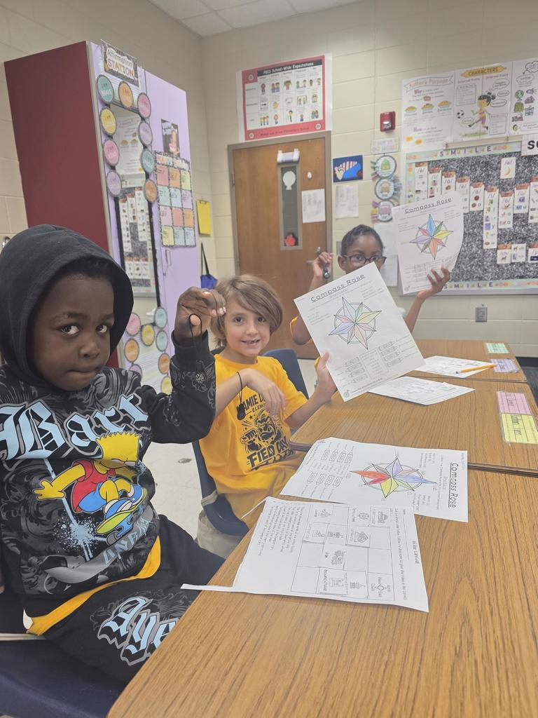 students practice using a compass rose