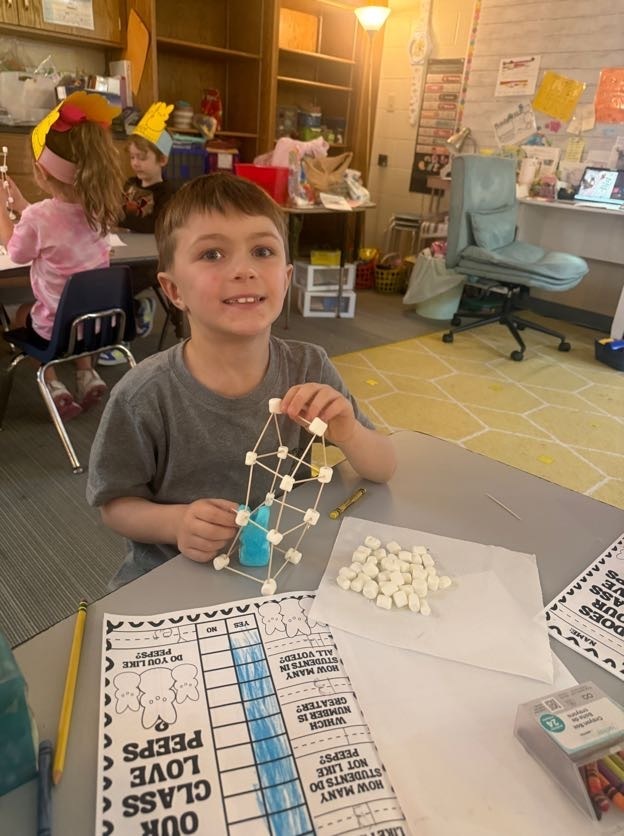 Student showing off their assignment