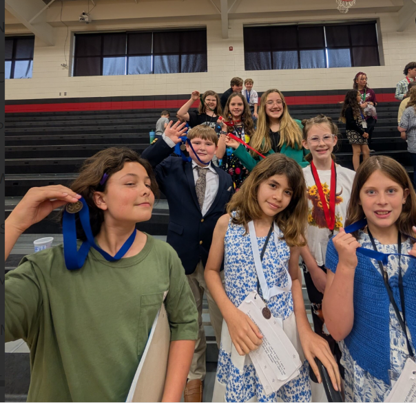 4-H students showing off their medals at competition