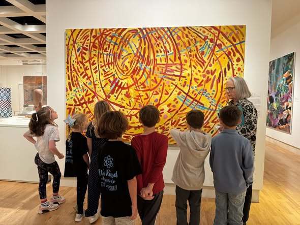 students looking at painting