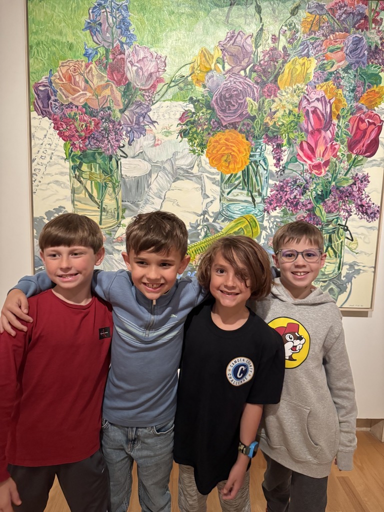 4 students in group photo smiliing