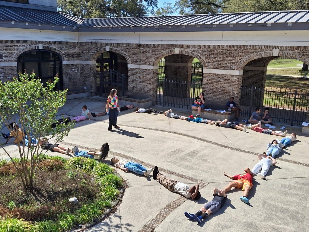 students laying down forming a rectangle
