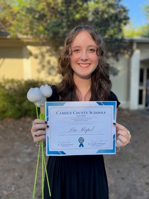 Lia Mapel holding her Young Georgia Authors award.