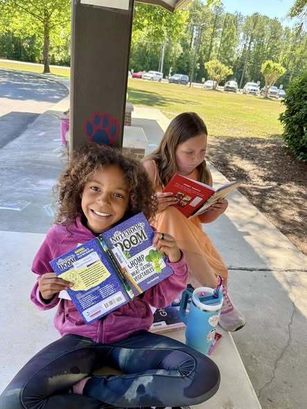 students reading outside