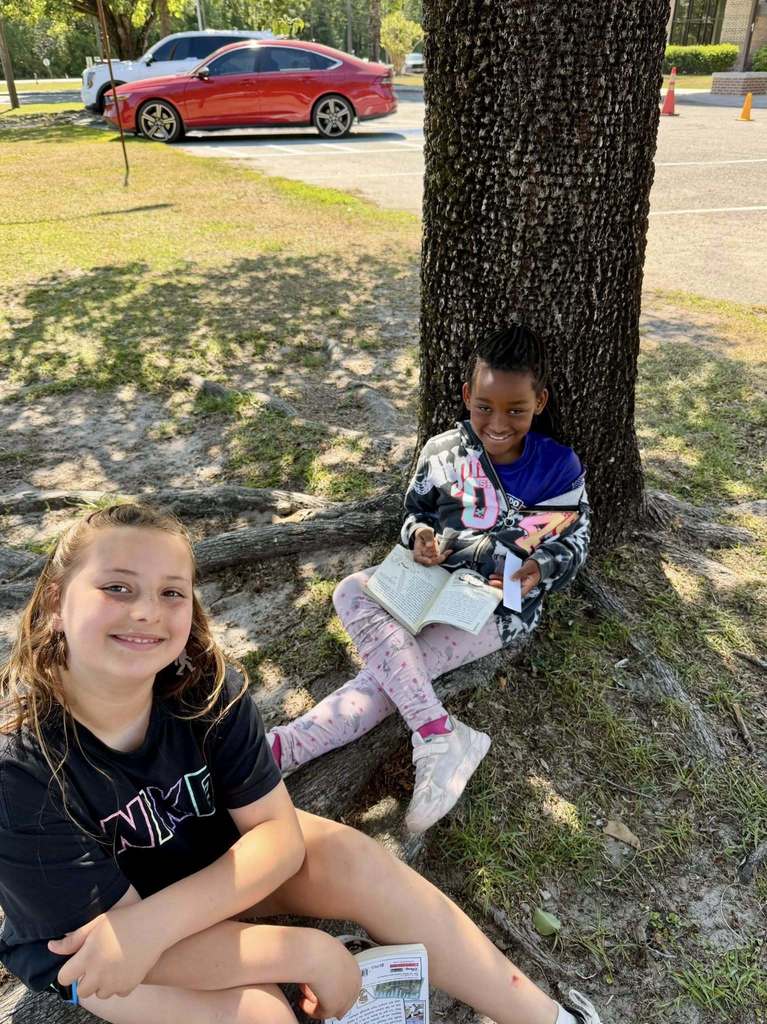 students reading outside