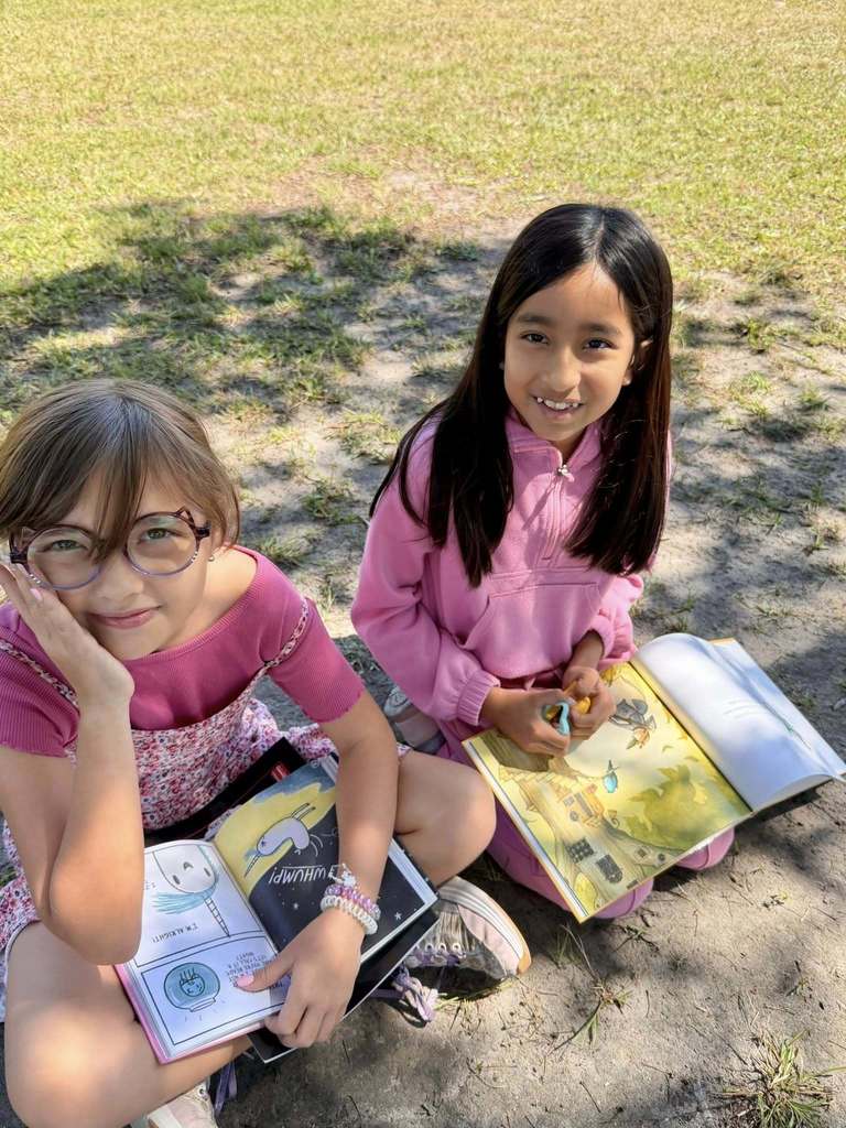 students reading outside