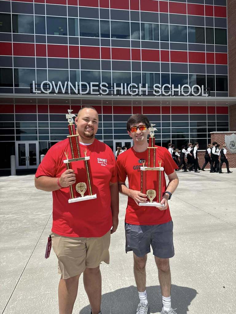 instructors holding trophies