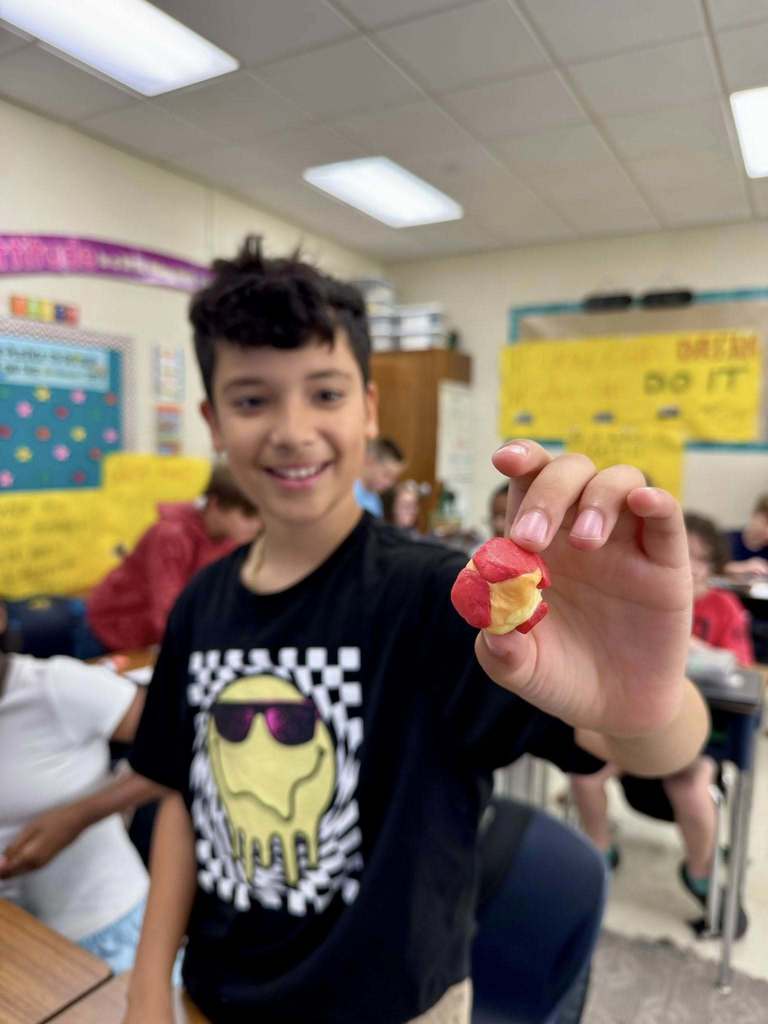 student holding his project