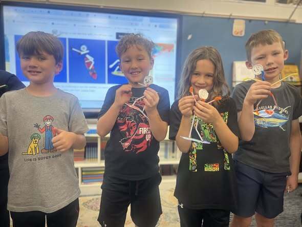 students showcasing their pipe cleaner surfers