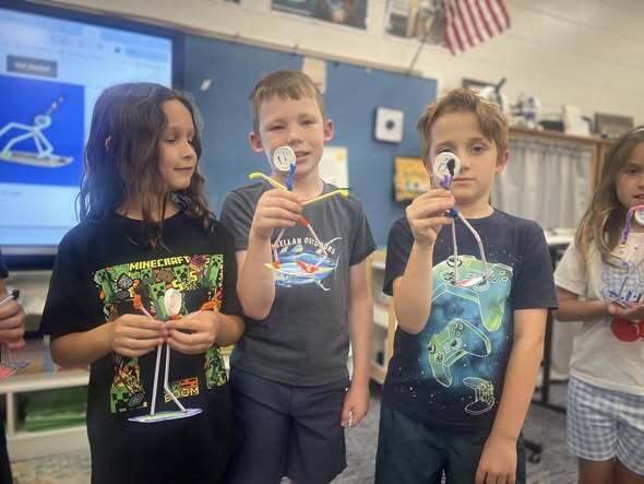 students showcasing their pipe cleaner surfers