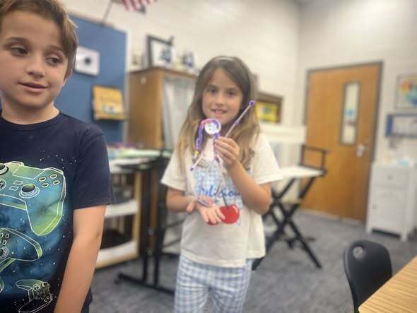 students showcasing their pipe cleaner surfers