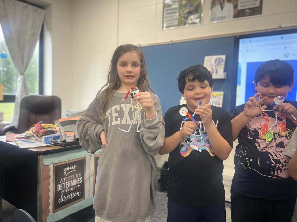 students showcasing their pipe cleaner surfers