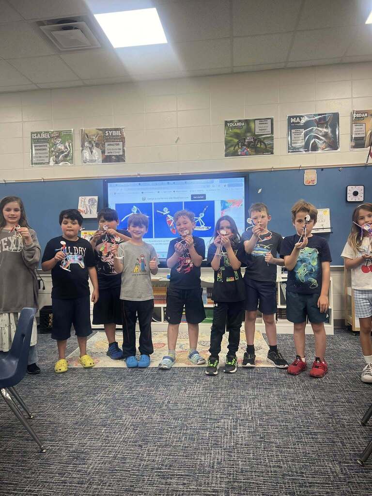 students showcasing their pipe cleaner surfers