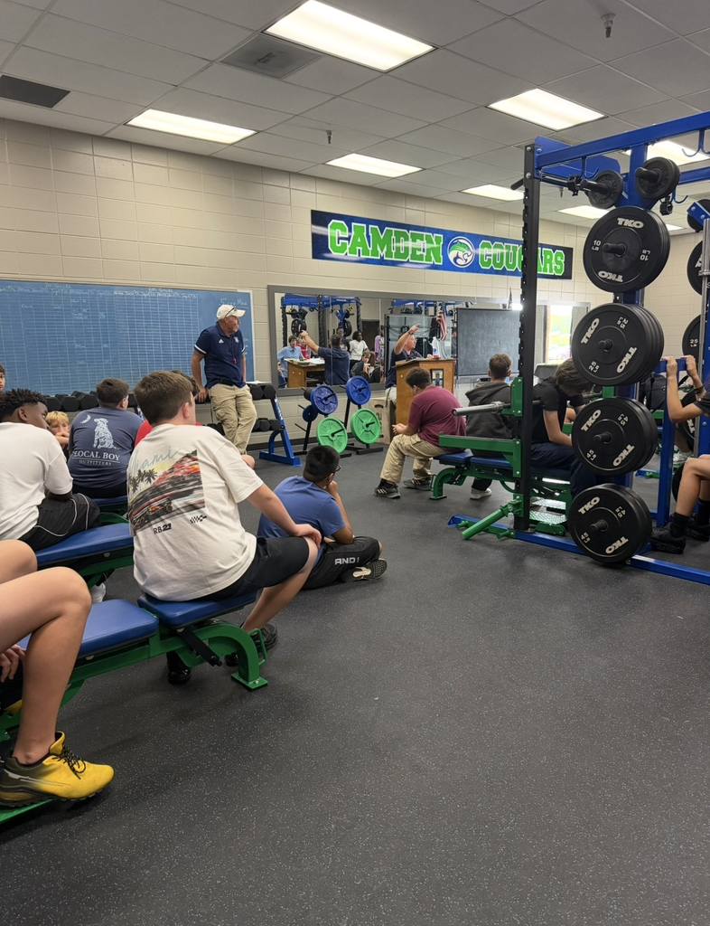 8th graders in weight room with coaches
