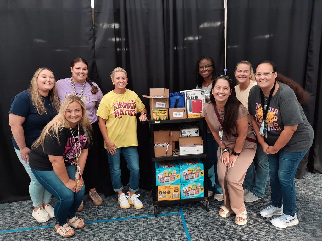DLR 1st and 2nd grade teachers with cart of donated supplies and snacks.
