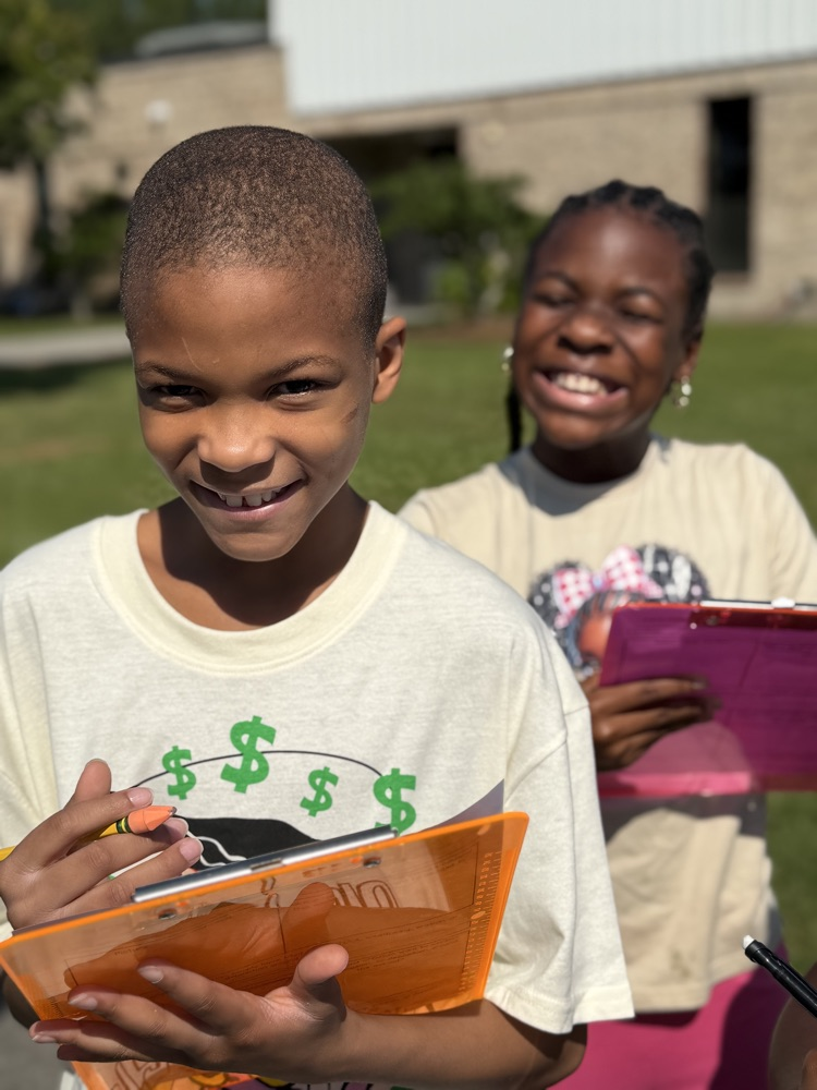students writing on clipboards