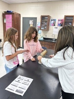Students cooperatively working to stack cups