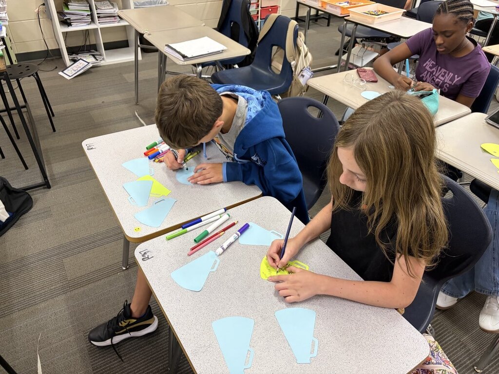 Students making encouraging notes for teachers