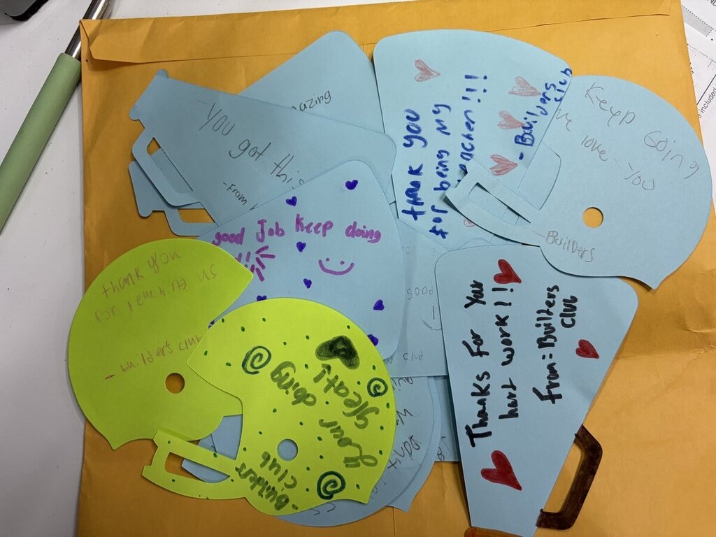Students making encouraging notes for teachers