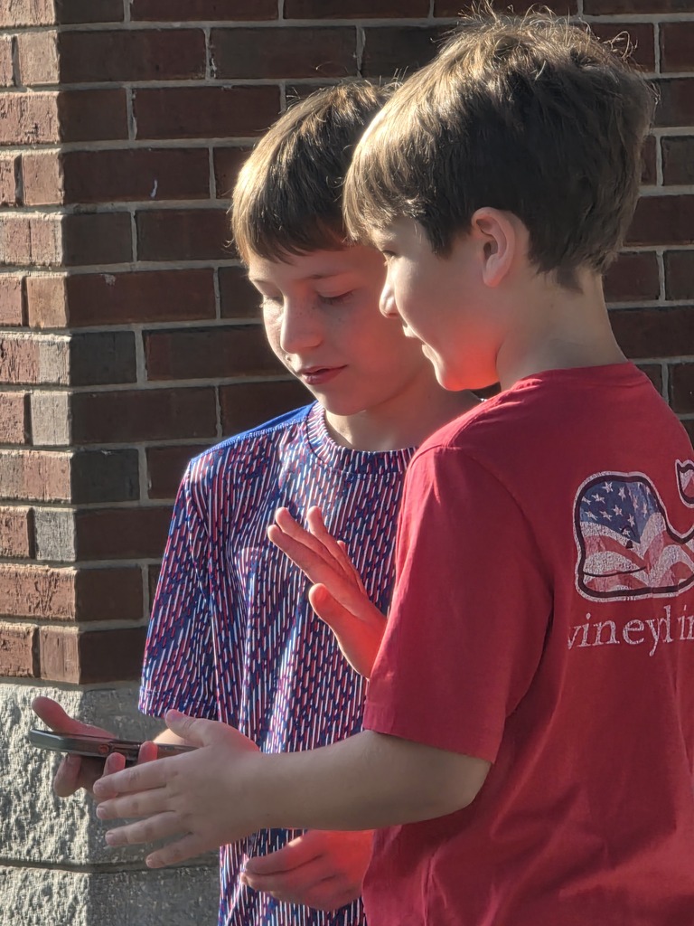 Sugarmill Elementary students partnered with local military members to honor 9/11 by singing "God Bless the U.S.A." by Lee Greenwood and clapping as the flag was raised to half-staff following a guest service member's lesson on its solemn meaning.