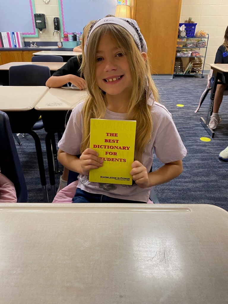 Student smiling with Dictionary