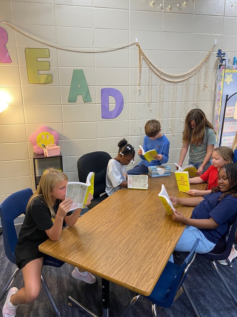 students looking through dictionaries