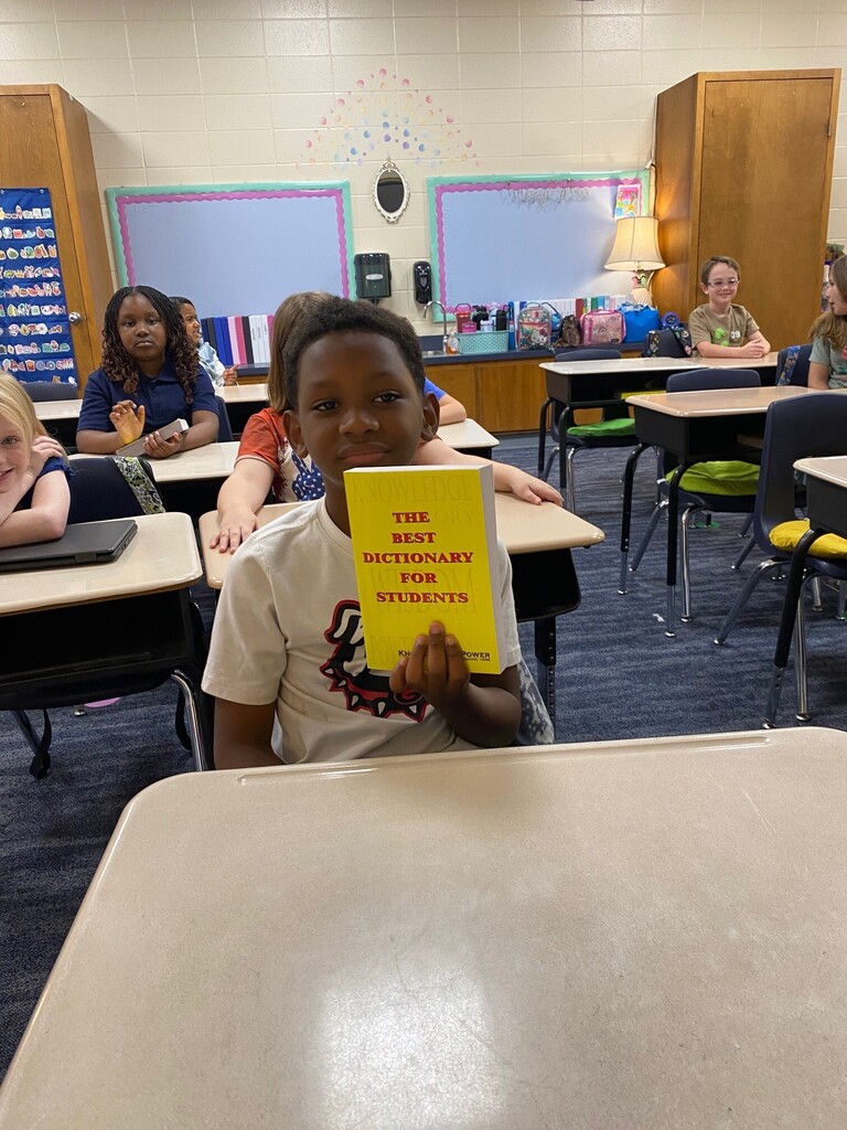 Student smiling with Dictionary